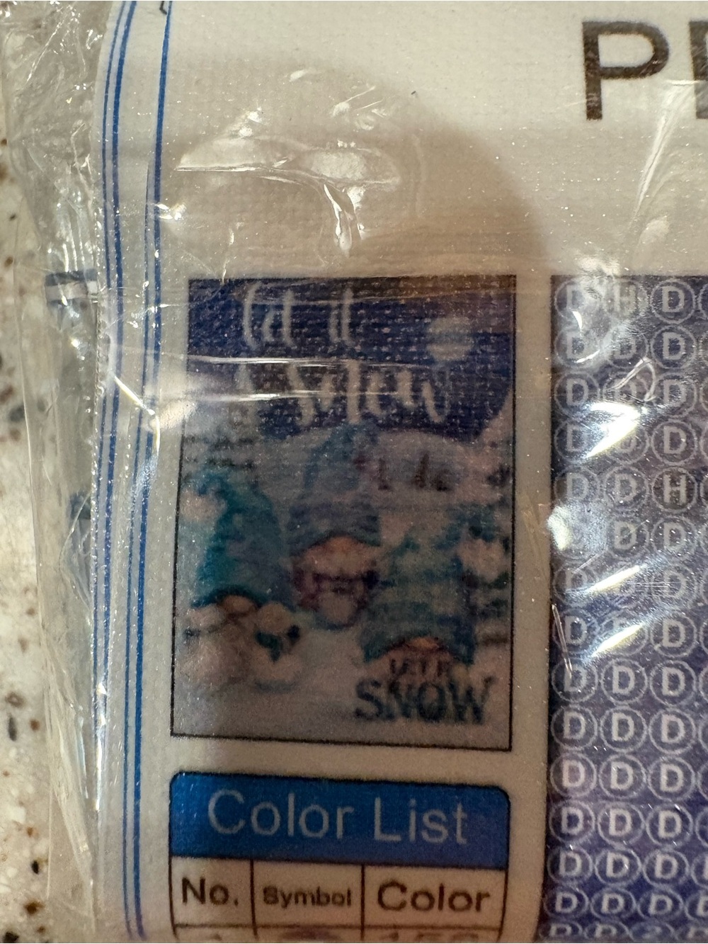 packaged diamond painting kit featuring a winter scene, three gnomes Let It Snow